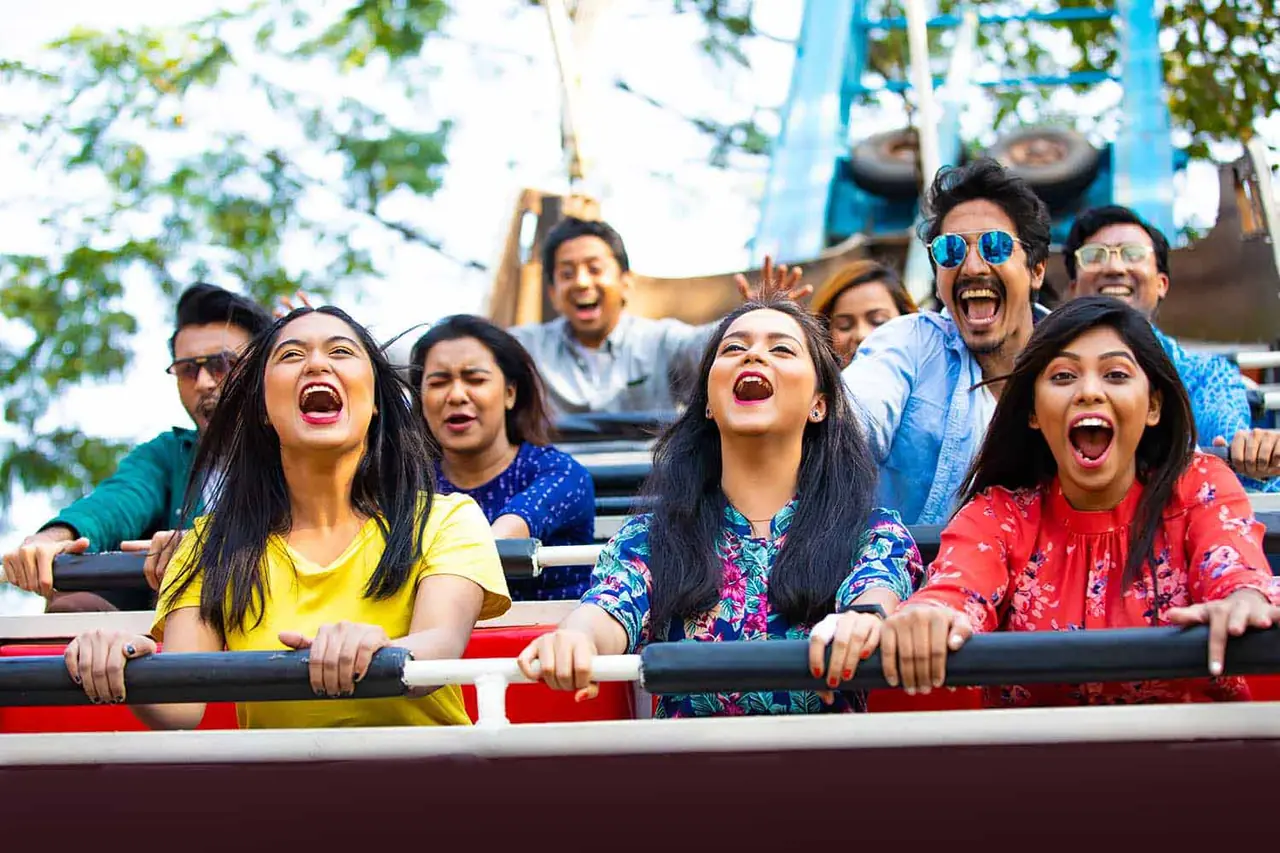 Friends screaming on a roller coaster